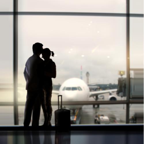 couple in airport, ready to fly