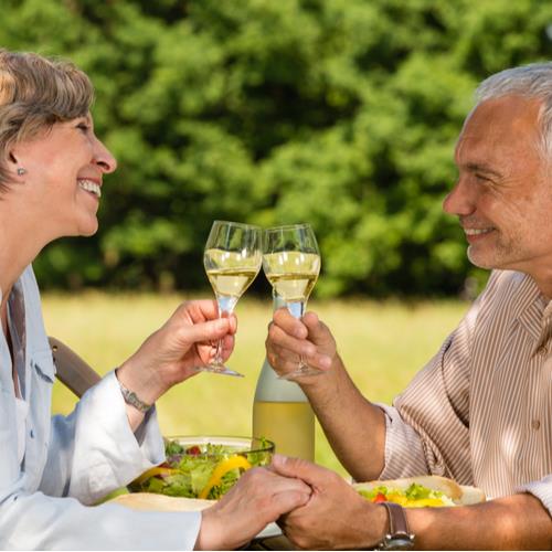 mature couple, smiling, having wine