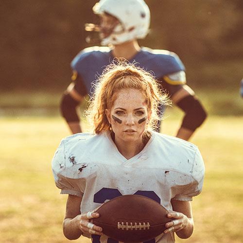 woman in football gear, playing football on a date