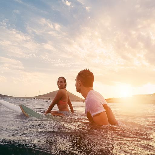 Couple in Hawaii surfing