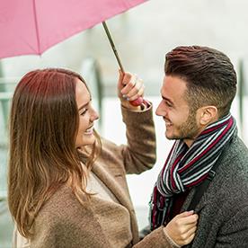couple sharing umbrella, falling in love