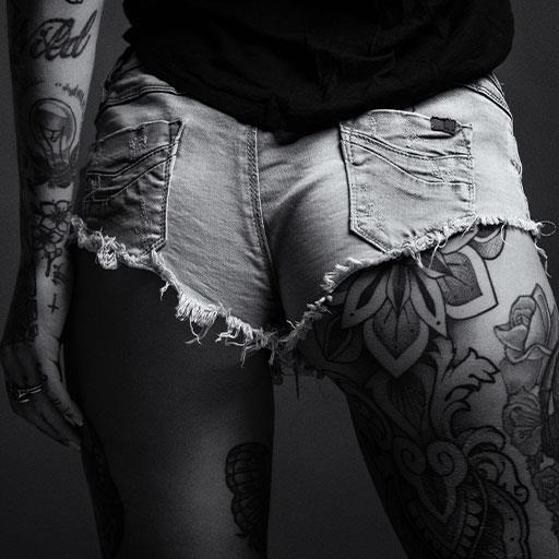 inked womans bum, inked in hotpants