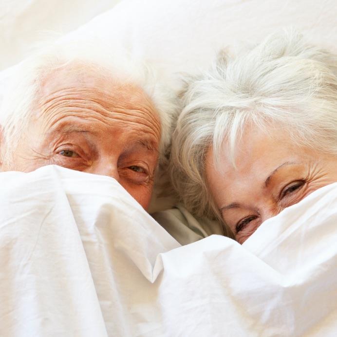 older woman and man in bed